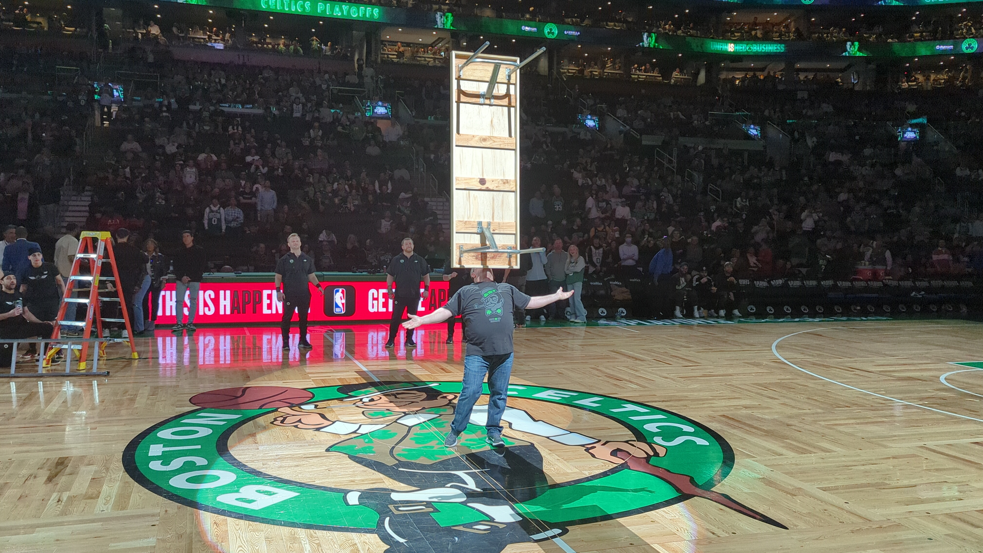 Balancing tall bookshelf at Celtics halftime